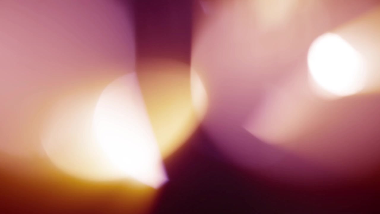 Varmfargede lyslekkasjer og bokeh-effekt på mørk bakgrunn