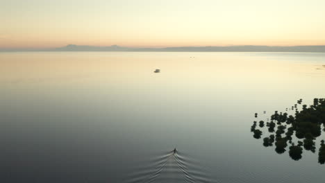 Aerial-showing-a-fishing-boat-on-Panglao-Island-with-sunset,-Bohol,-Philippines