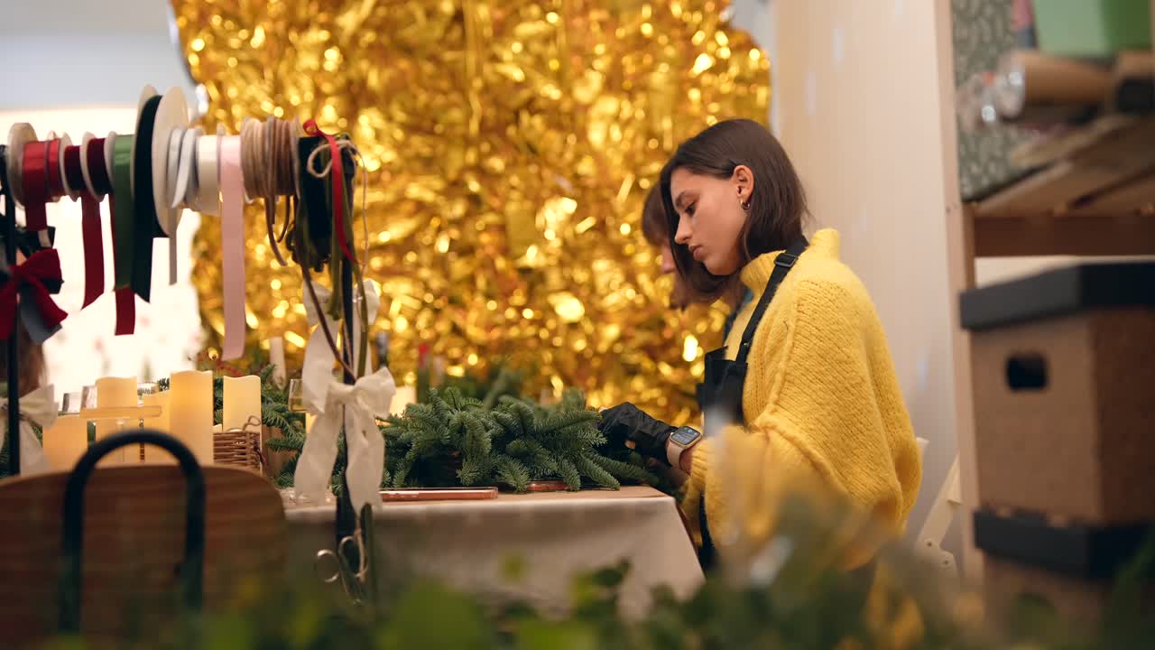 Women making Christmas wreaths
