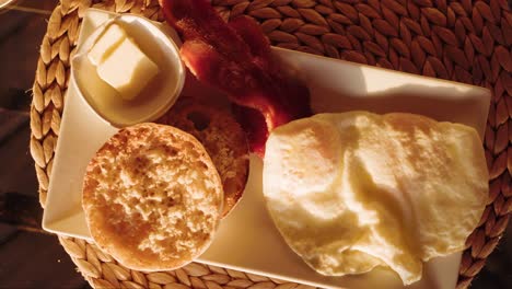 sunrise breakfast plate with english muffin bread, egg, bacon, cozy morning