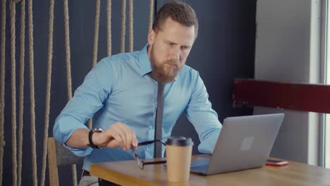 businessman working at a laptop in a cafe