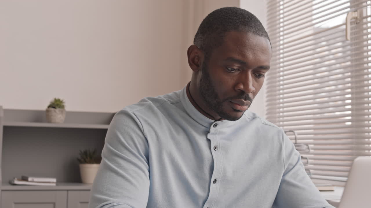African-American Man Working at Desk