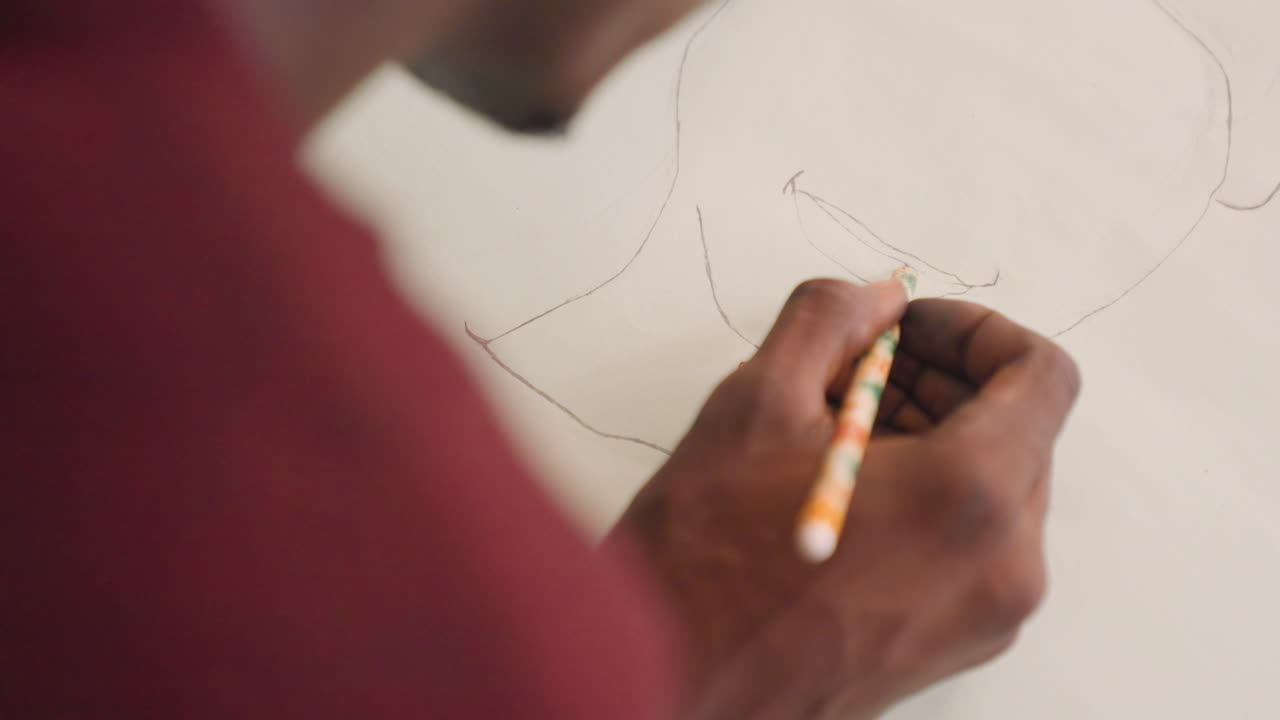Apprentice meticulously tracing sketches. Close view of ink hand drawing in classroom with sunlight. Detailed depiction of mural apprentice gently outlining guide lines with precision