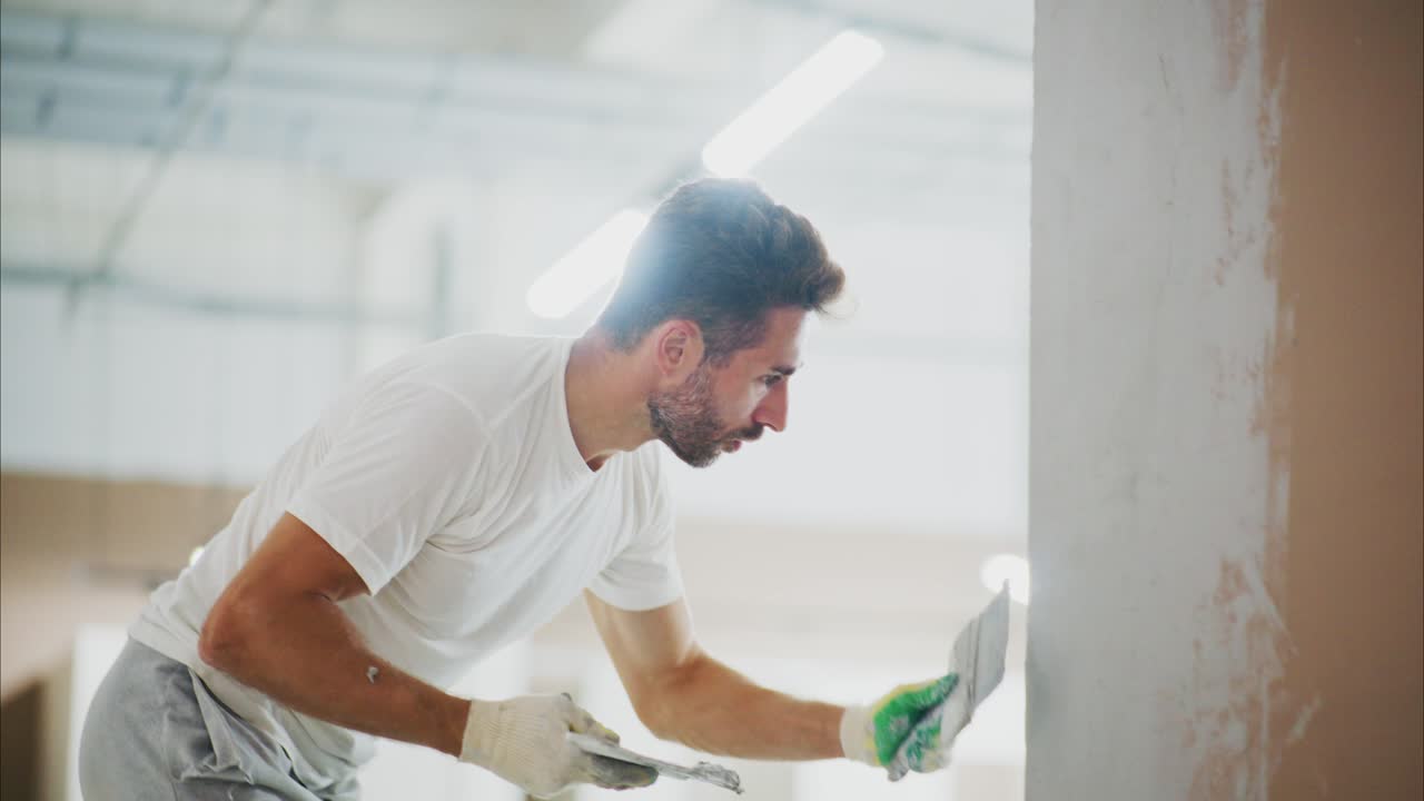 Skilled Artisan Smooths Wall Surface with Precision: A Step-by-Step Transformation in Modern Home Renovation Techniques for Interior Design Enthusiasts