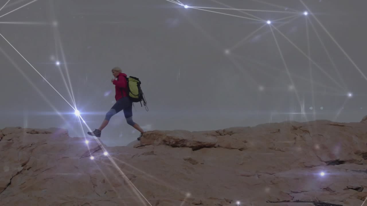 Hiker stepping ridge crest starting traversing for safety with tech network pulsing around backpack