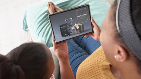 African-american-mother-and-daughter-using-tablet,-online-shopping-on-cyber-monday,-slow-motion