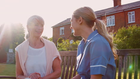 nurse talking to senior woman in residential care home