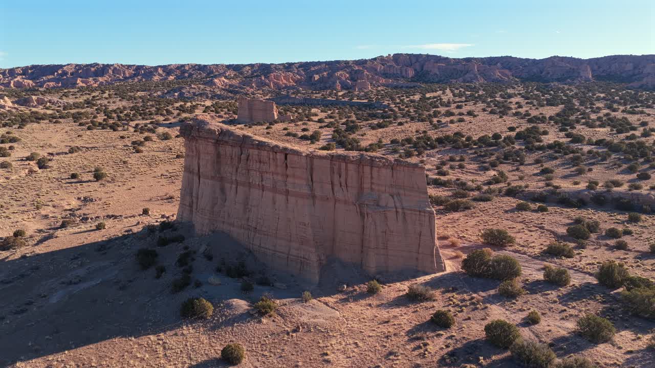 Striking view of the sheer cliff face, highlighting the deep grooves and stratified colors of the exposed rock. This geologic formation resembles an alien structure in the remote American Southwest