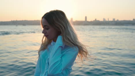 beautiful girl enjoys sunset view of bosphorus and istanbul, a popular destination in istanbul, turkey
