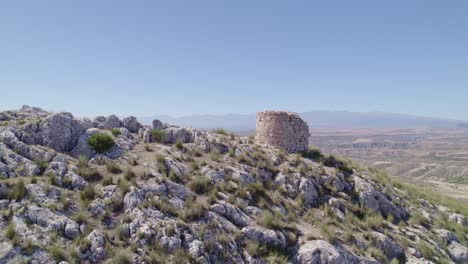 ruins of a medieval watchtower on a rocky mountaintop. aerial view of the watchtower and horizon. spain