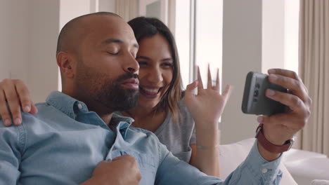 happy mixed race couple using smartphone video chatting to friend smiling excited enjoying online communication blowing kiss waving goodbye