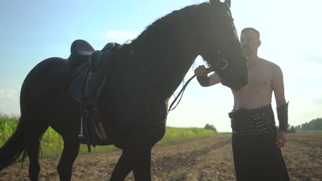 a man stands near a horse in a field 01