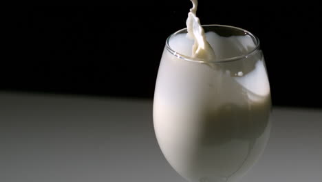 strawberry falling in glass of milk