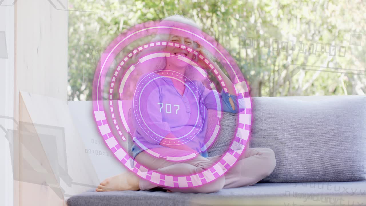 Mature woman holding phone, smiling as call causing pink tech HUD overlaying rotating numeric rings