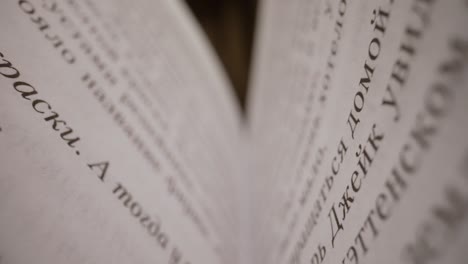 text on the pages of an open book macrophotography wide angle dolly shot. macro photography open book