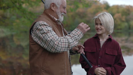 grandfather and grandson bonding while fishing in autumn