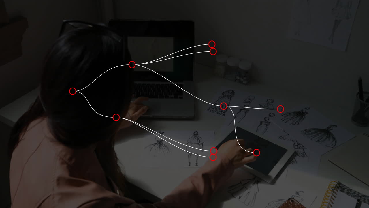 Fashion designer using tablet in studio, with animated color swatches floating over sketches