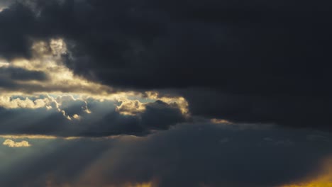 dramatic sunset sky time lapse, bright sunlight and dark silhouette of clouds as a background, extreme weather