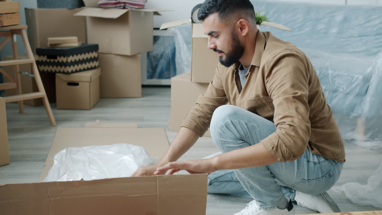 Man Unpacking Furniture in a New Apartment