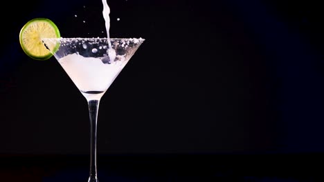 margarita being poured into a cocktail glass