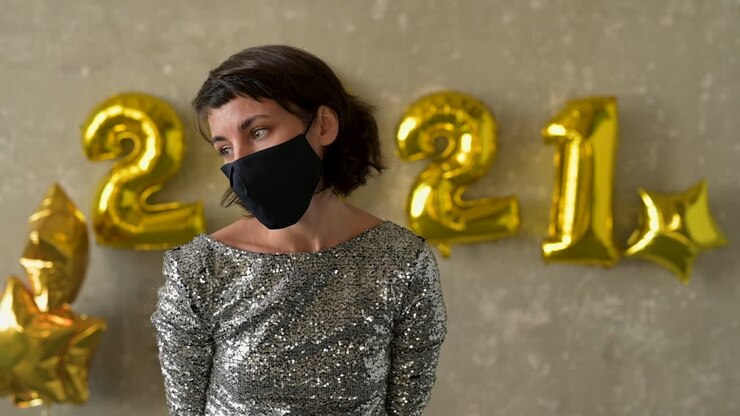 New year and COVID-19. Young woman don't know. Female wearing face mask is not sure, worried and have no idea.