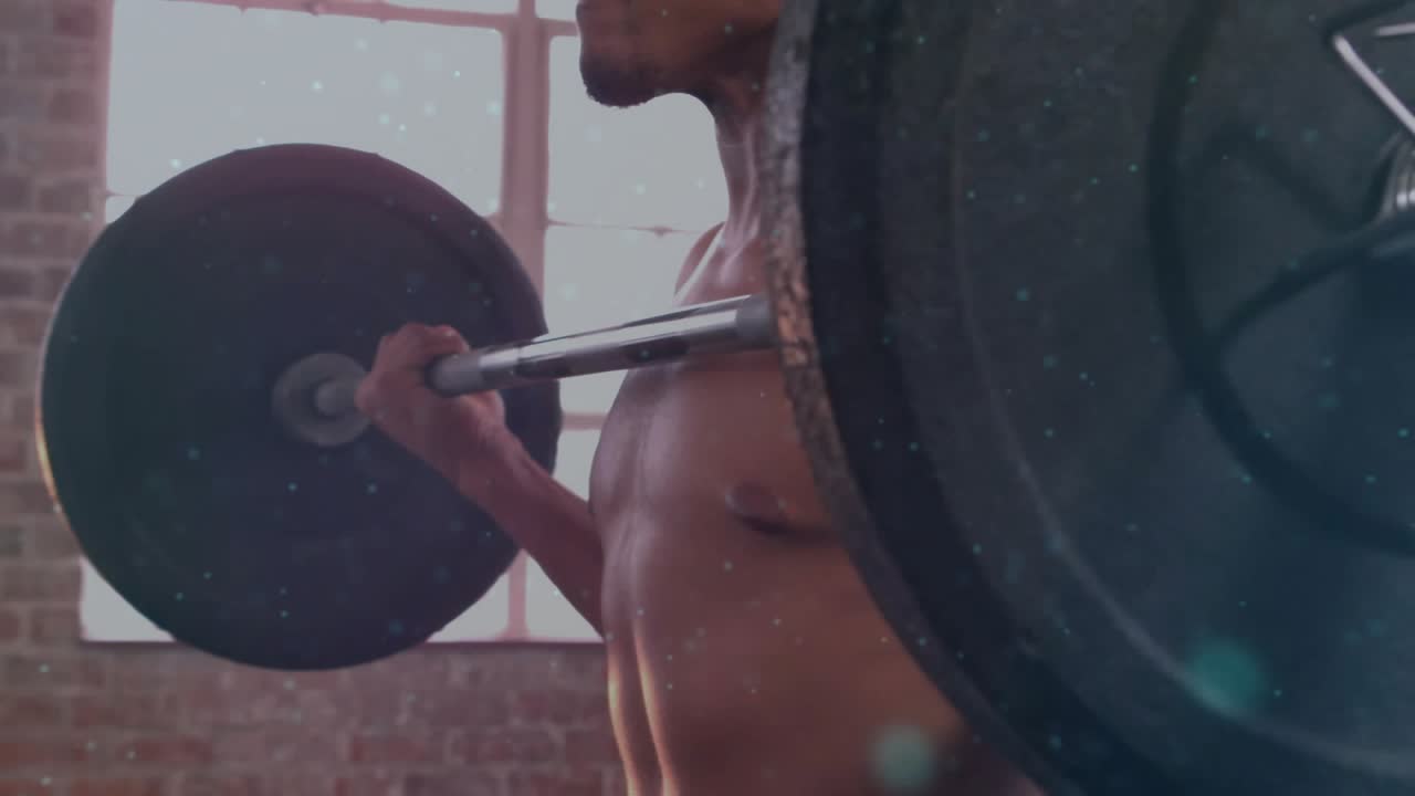 Man gripping loaded bar, starting particles and rotating globe with 5G over chest showing tech