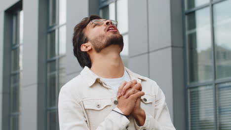 retrato de un hombre indio orando con los ojos cerrados a dios pidiendo bendición ayuda perdón al aire libre