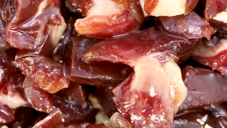 serrano ham chopped in small pieces close up view, macro shot in 4k