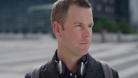 portrait successful young business man turns head looking serious in city professional caucasian male sunny urban background