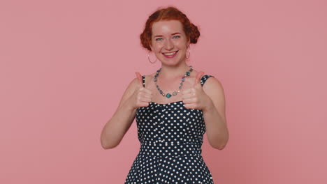 redheaded woman raises thumbs up agrees or gives positive reply recommends advertisement likes good