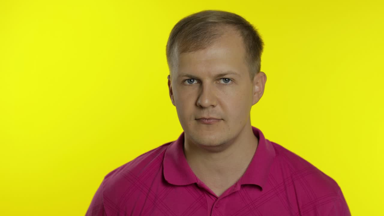 Portrait of caucasian man posing in t-shirt. Smiling handsome guy show OK sign. People emotions
