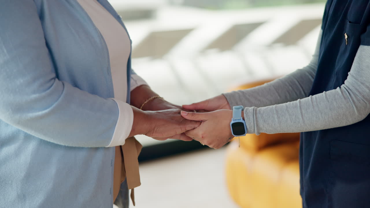 Caregiver Gently Holding Hands with Senior Woman