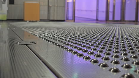 people walking on innovative floor with bumps which removes fine dust and viruses from shoes installed at seoul forest subway station, south korea - close-up