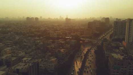 aerial over shahrah e faisal road in karachi with against golden yellow sunset