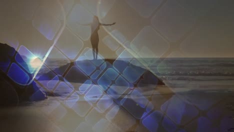 animation of blue squares over caucasian woman praciticing yoga on beach