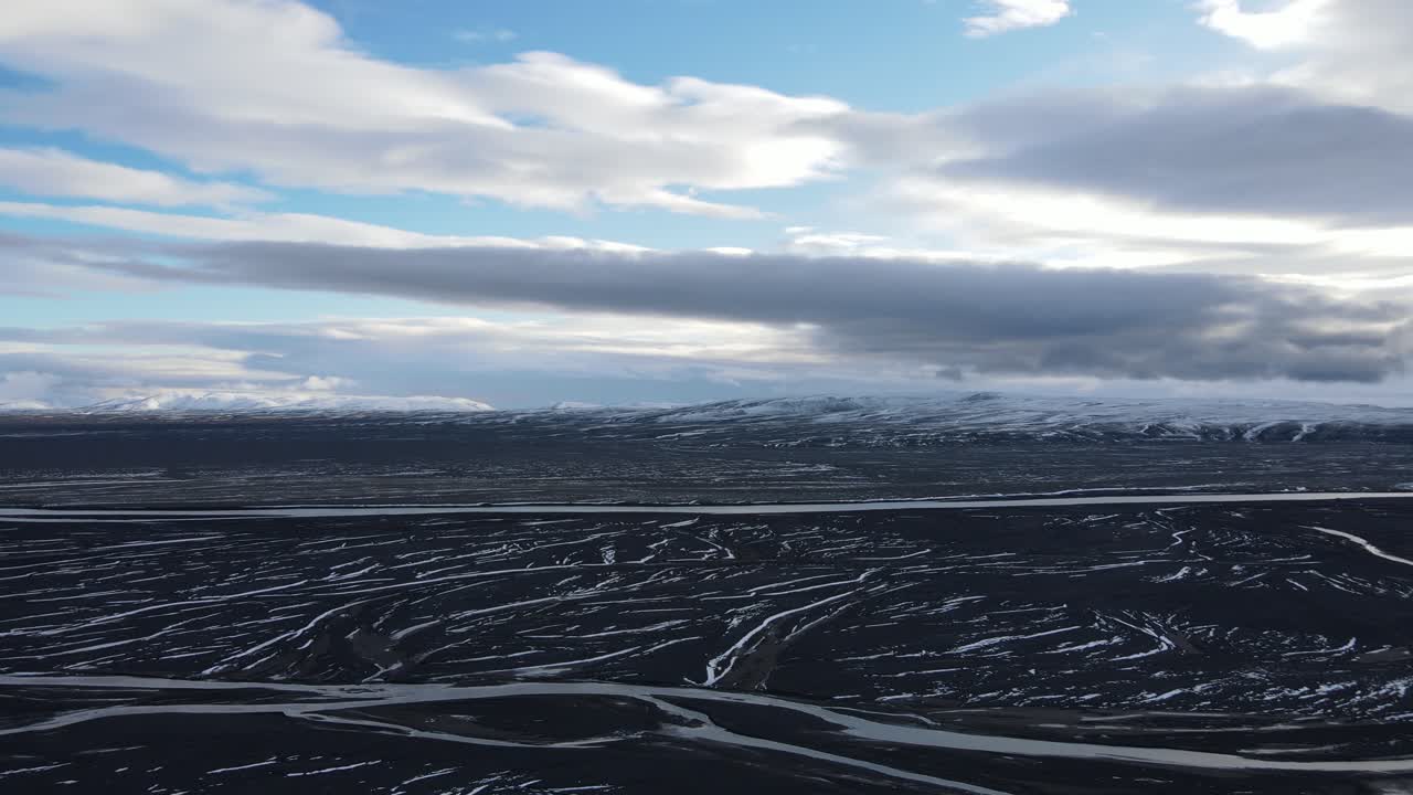 Flying above glacier rivers in a desert on Iceland