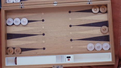 man and woman playing backgammon and rolling dice