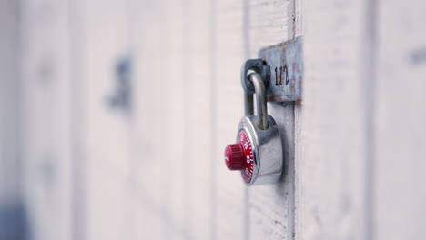 rack focus of padlocks on wooden lockers.
