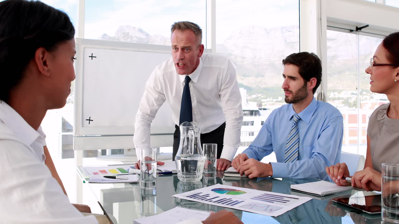 Business manager giving out to his staff