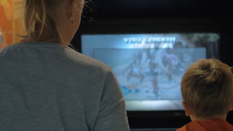 Mother-and-son-playing-on-amusement-machine