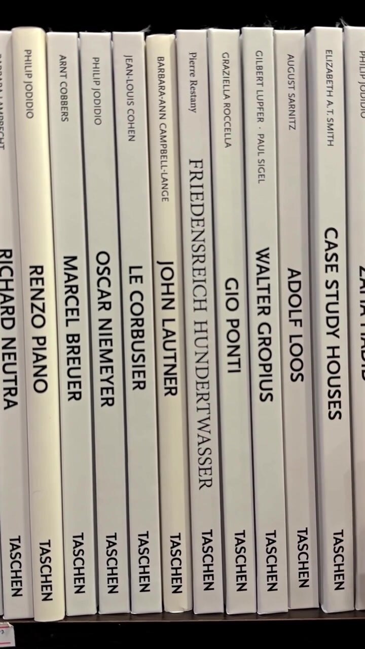 Hand Touching Spines of Architecture Books on a Shelf