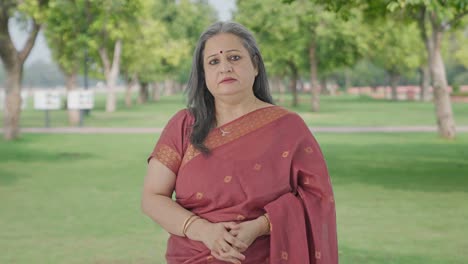 Indian-old-woman-looking-to-the-camera-in-park