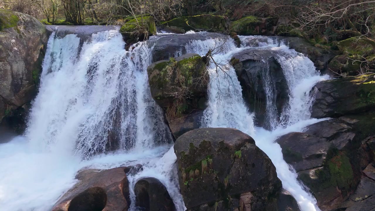 İspanya'da granit kaya oluşumu üzerindeki Fervenza Da Noveira Şelalesi. Yavaş çekim.