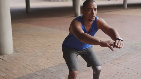 side view man with prosthetic leg doing squats