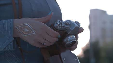 woman holding a vintage camera