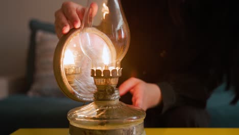 Woman-Lights-An-Old-Oil-Lantern---Close-Up