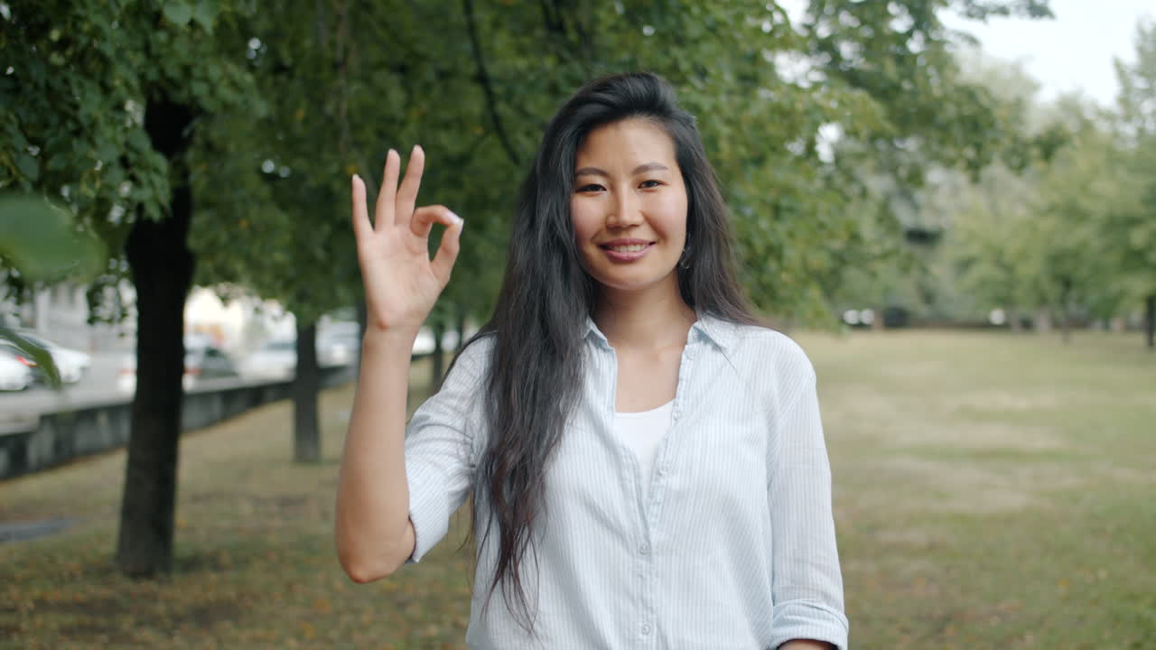 Young Asian woman smiling in a park