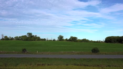 motorcycle wheelie past static low aerial in rural area