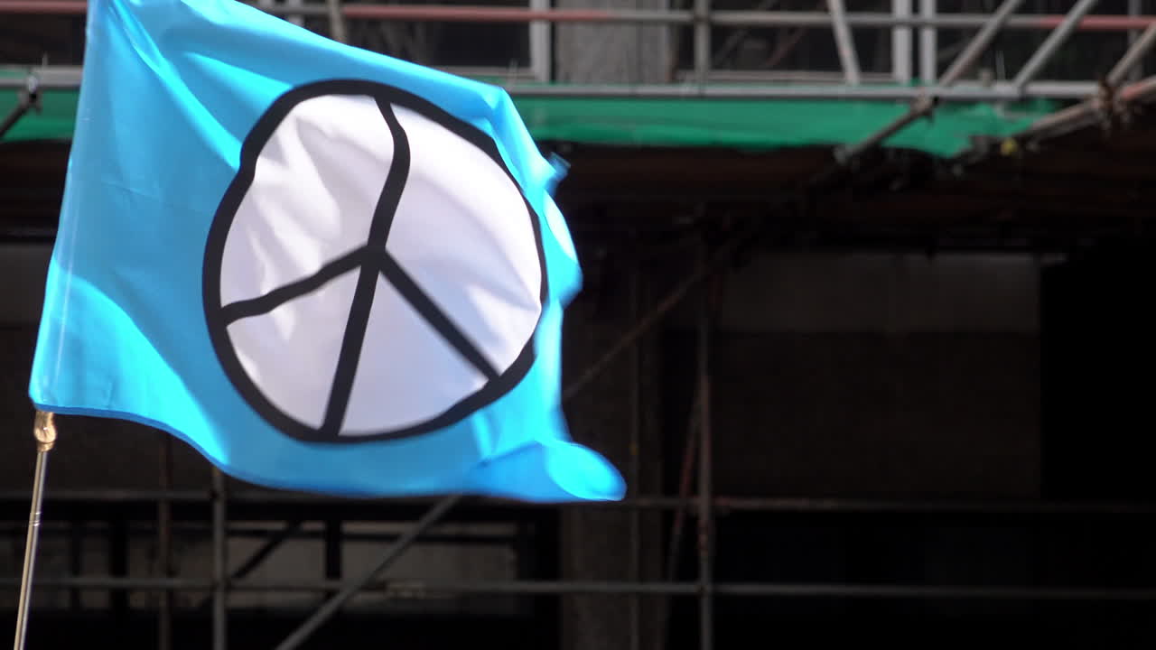 Blue Peace Symbol Flag Waving in the Wind
