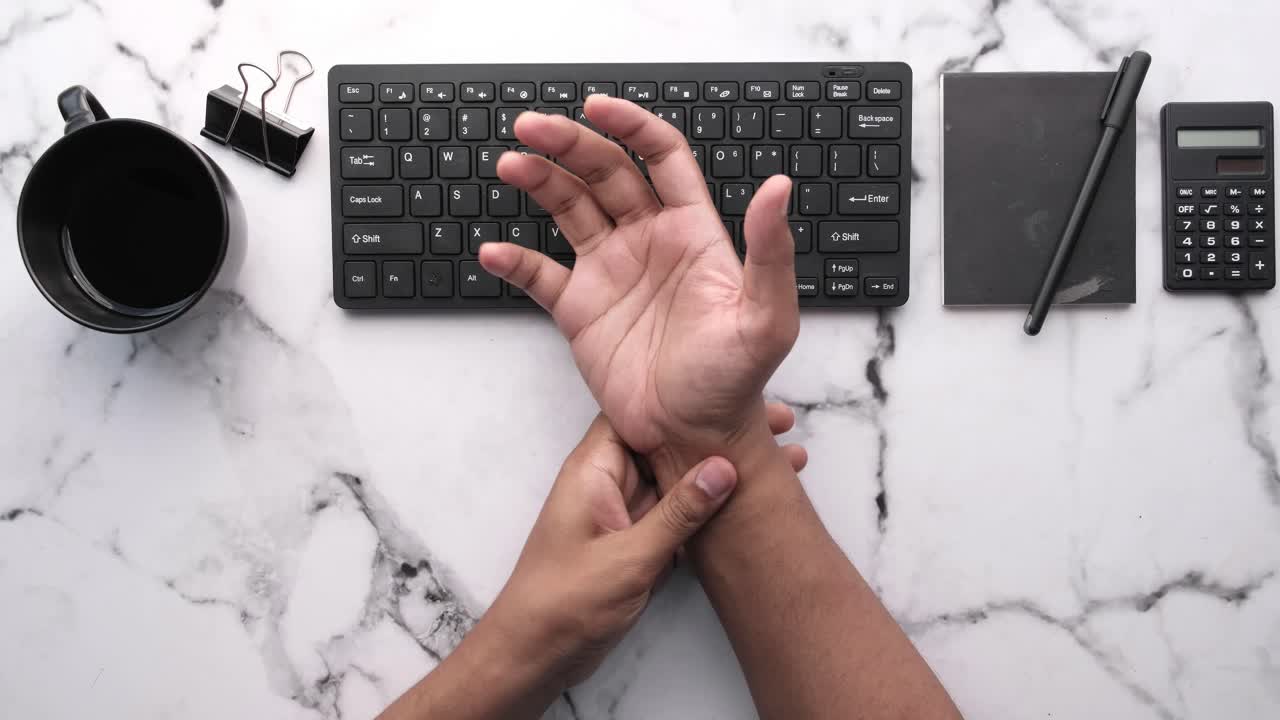 persona que escribe en el teclado, posible dolor en la muñeca